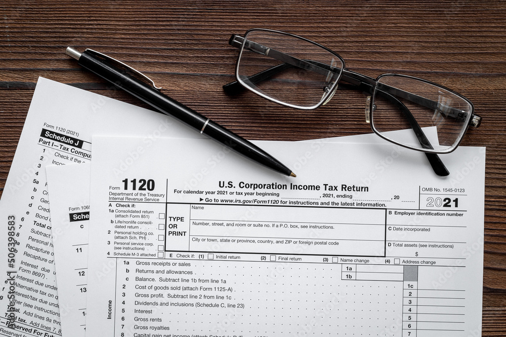 Businessman table with US tax form and pen. Culculating and payment of taxes Businessman table with US tax form and pen. Culculating and payment of taxes