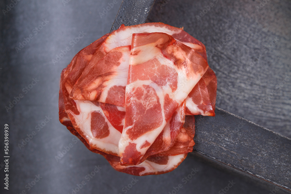 Coppa di Parma ham. Italian sliced cured coppa with spices. Raw ham. Crudo or jamon.
