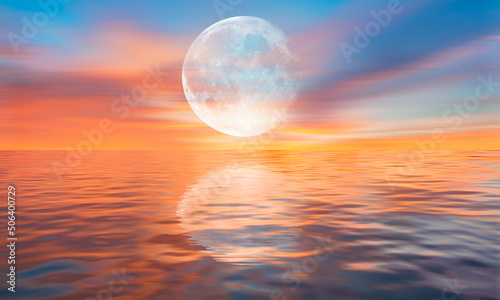 Full moon over the sea at sunset "Elements of this image furnished by NASA"