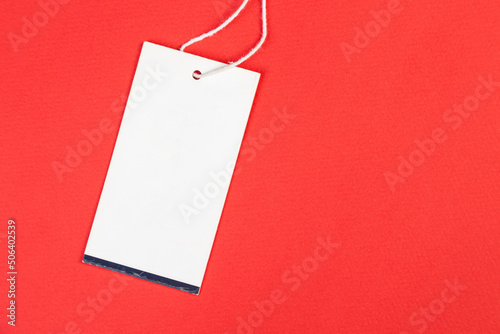 white price tag on a red isolated background, price tag for goods