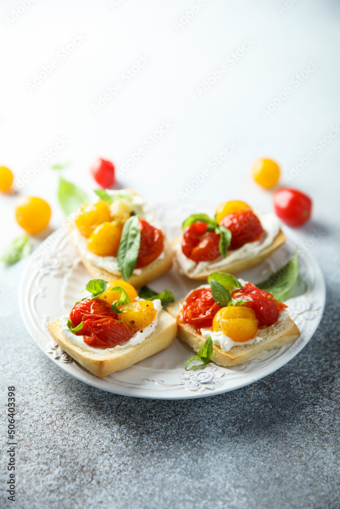 Tomato crostini with cream cheese and fresh basil Tomato crostini with cream cheese and fresh basil