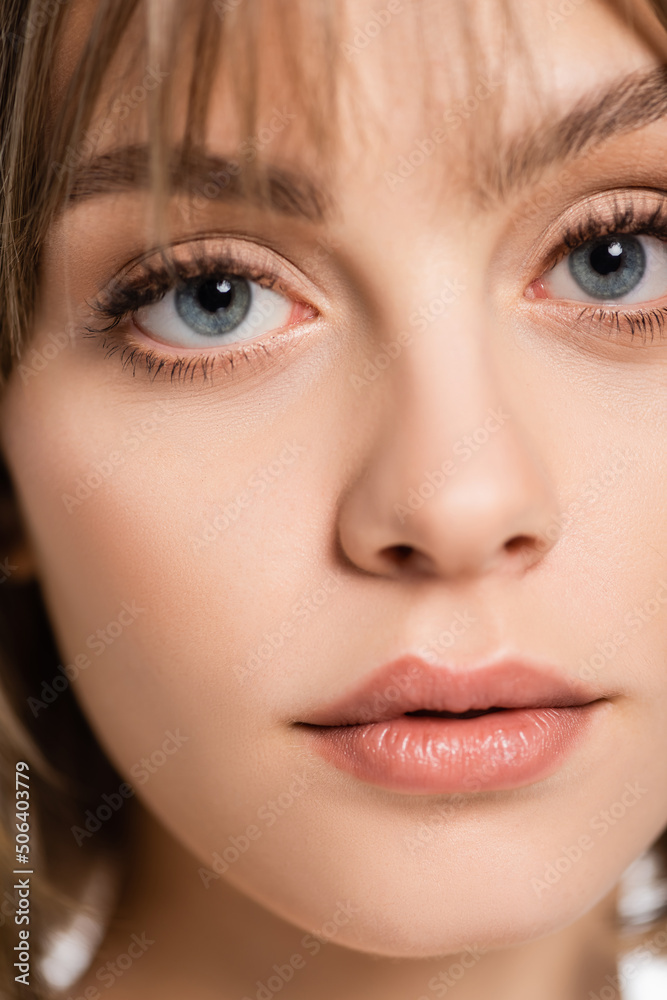close up view of young woman with bangs and blue eyes looking at camera close up view of young woman with bangs and blue eyes looking at camera