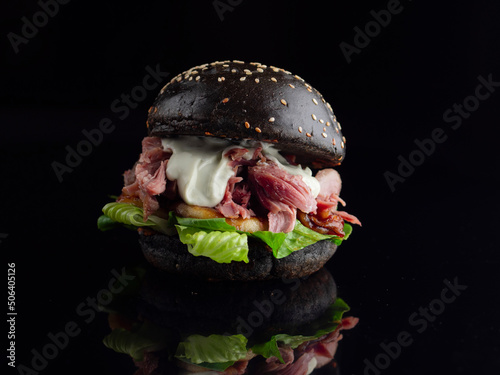 black burger with duck photo