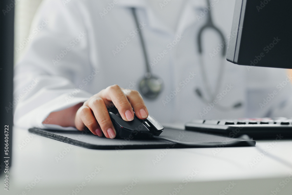 © Nattakorn - Closeup shot doctor's hand using computer working in hospital