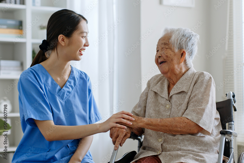 Young Asian woman, nurse, caregiver, carer of nursing home talking with senior Asian woman feeling happy at home Young Asian woman, nurse, caregiver, carer of nursing home talking with senior Asian woman feeling happy at home