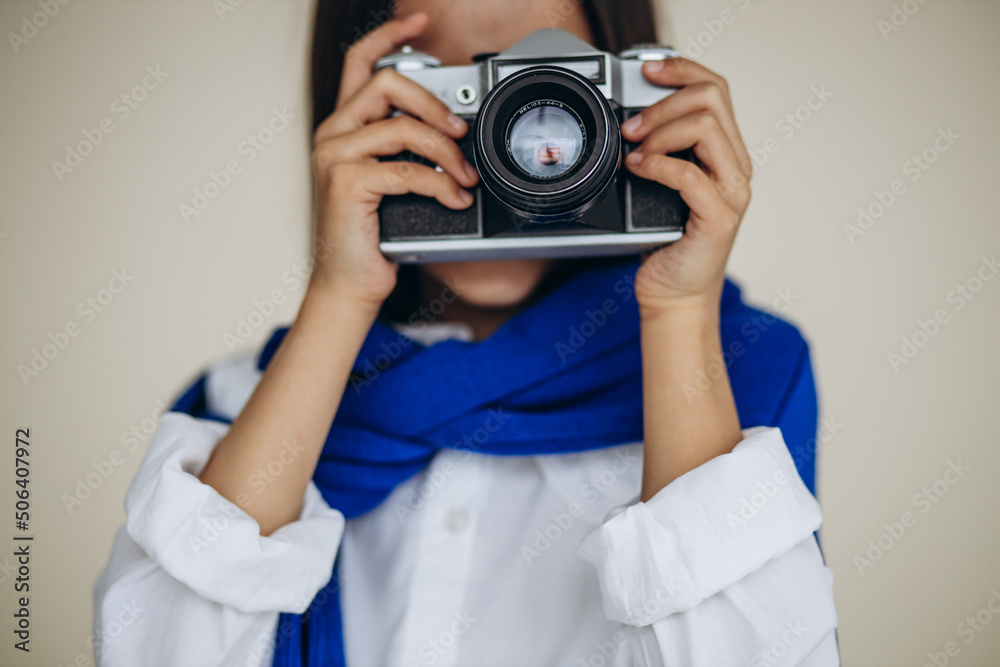 Cute girl holding camera and smiling Cute girl holding camera and smiling