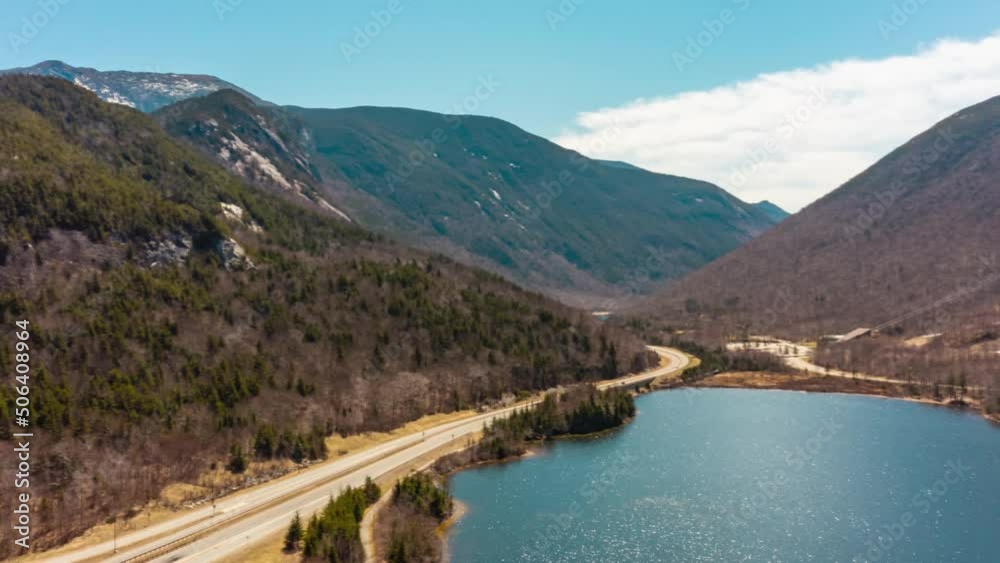 Drone Aerial motion time lapse of traffic on interstate through mountains shipping and receiving HD 30p Drone Aerial motion time lapse of traffic on interstate through mountains shipping and receiving HD 30p