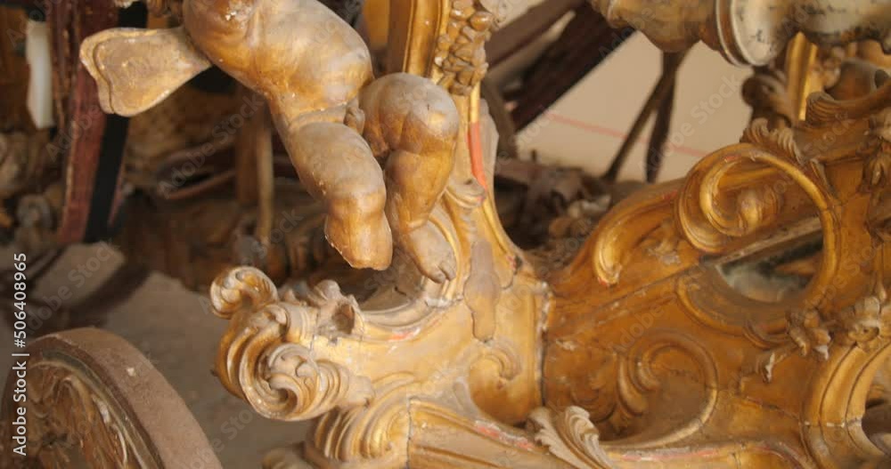 Close up shot of a wooden sculpture over a horse drawn carriage inside the museum in the Certosa di San Martino in Naples, Italy Close up shot of a wooden sculpture over a horse drawn carriage inside the museum in the Certosa di San Martino in Naples, Italy