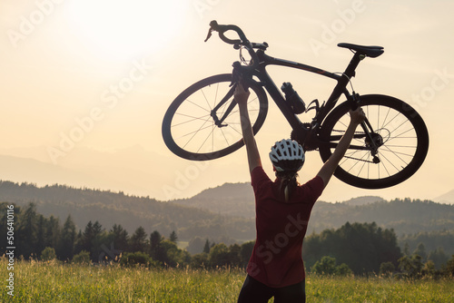 Woman road cycling on race bike outdoor in nature