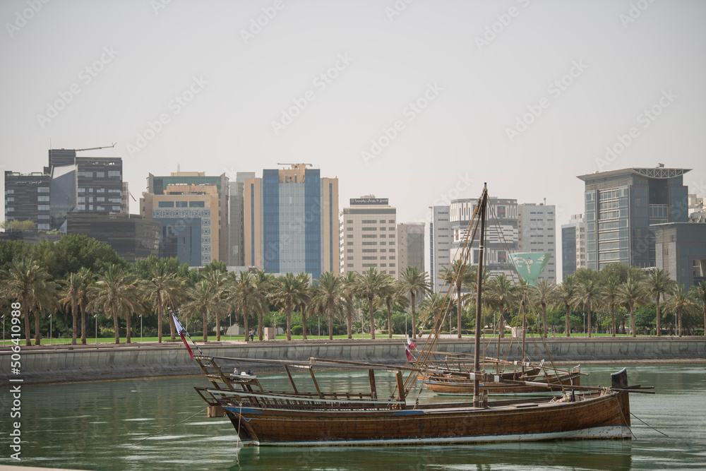 Doha,Qatar- April 24,2022 Traditional boats called Dhows are anchored in the port near the Museum of Islamic Art Park.