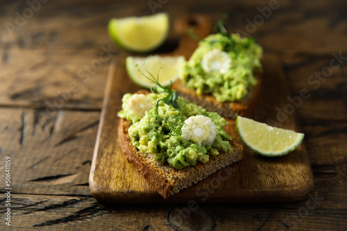 Homemade avocado toast with corn and lime