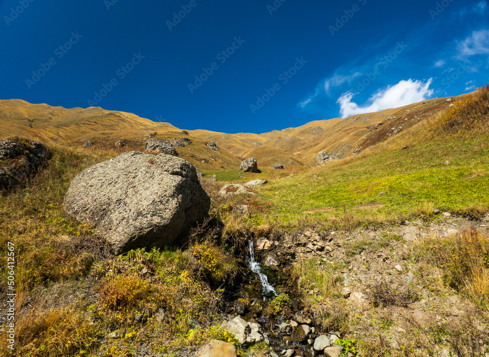 Mountain slope with brook and stones