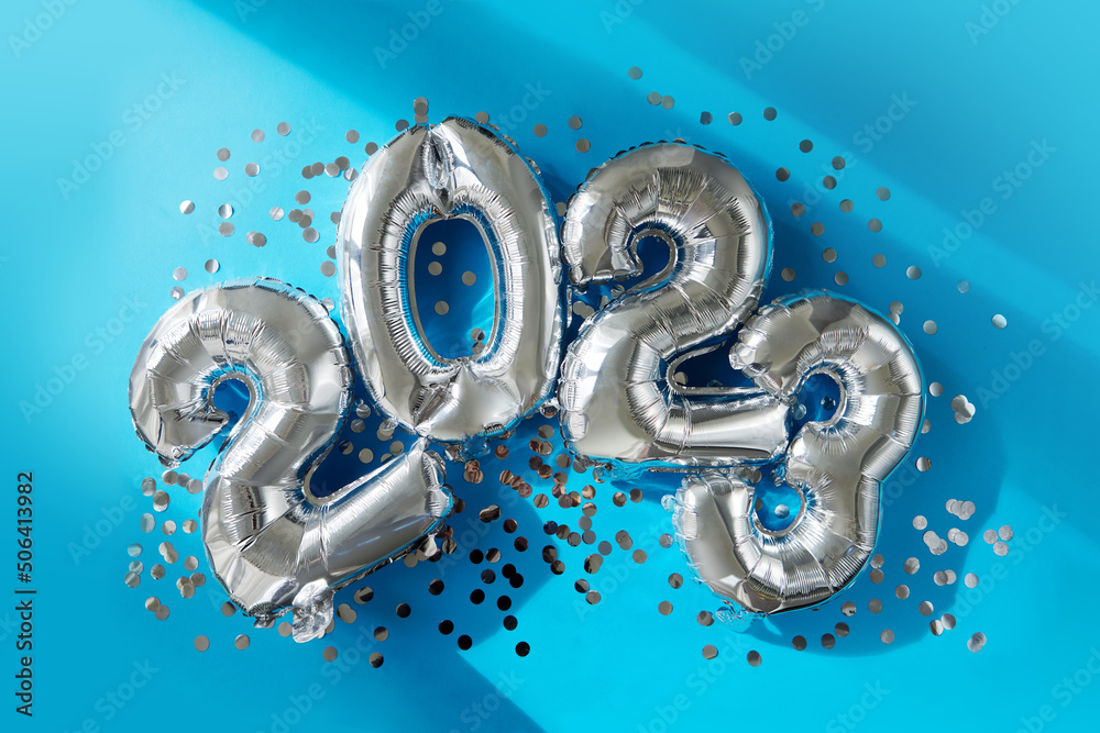 Silver numbers 2023 new year balloons among confetti in sunlight on blue background Happy new year celebration party. Greetings and congratulation Silver numbers 2023 new year balloons among confetti in sunlight on blue background Happy new year celebration party. Greetings and congratulation
