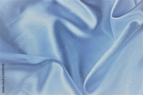 Light blue pearl silk gathered in folds. Satin or some other noble material.