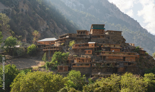 Wooden dwellings in Rumbur valley, one of the three valleys inhabited with Kalasha people located in Chitral District, Khyber Pakhtunkhwa, Pakistan photo