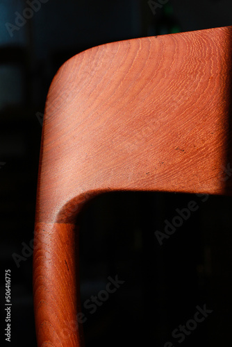 A danish mid century modern teak chair from the 60s vintage standing in the dining living room with paper cord seat teak wood 50s 70s retro original isolated on refurbished in living room closeup loft