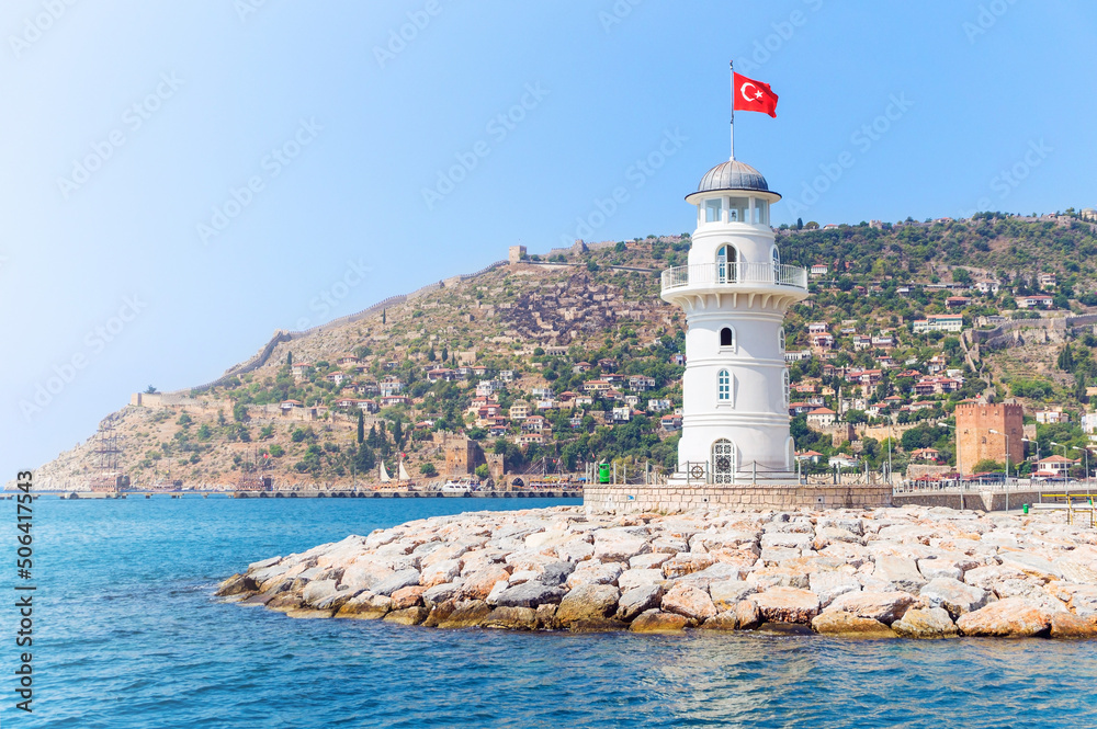 Alanya lighthouse with fortress on the background on a sunny summer day