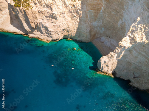 aerial view of a sailboat near a cliff in sea s greece