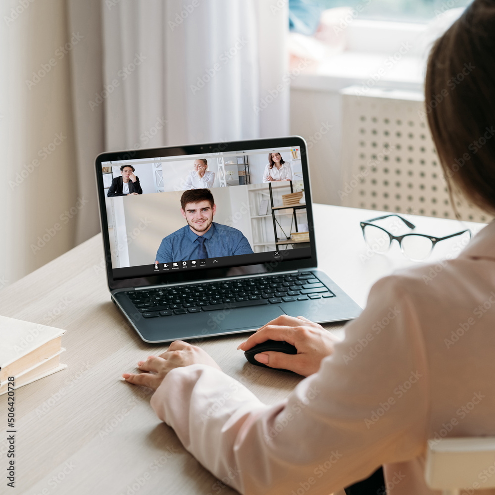 Work video chat. Digital interview. Online business management. Female executive discussing project with team on laptop screen at home virtual office.