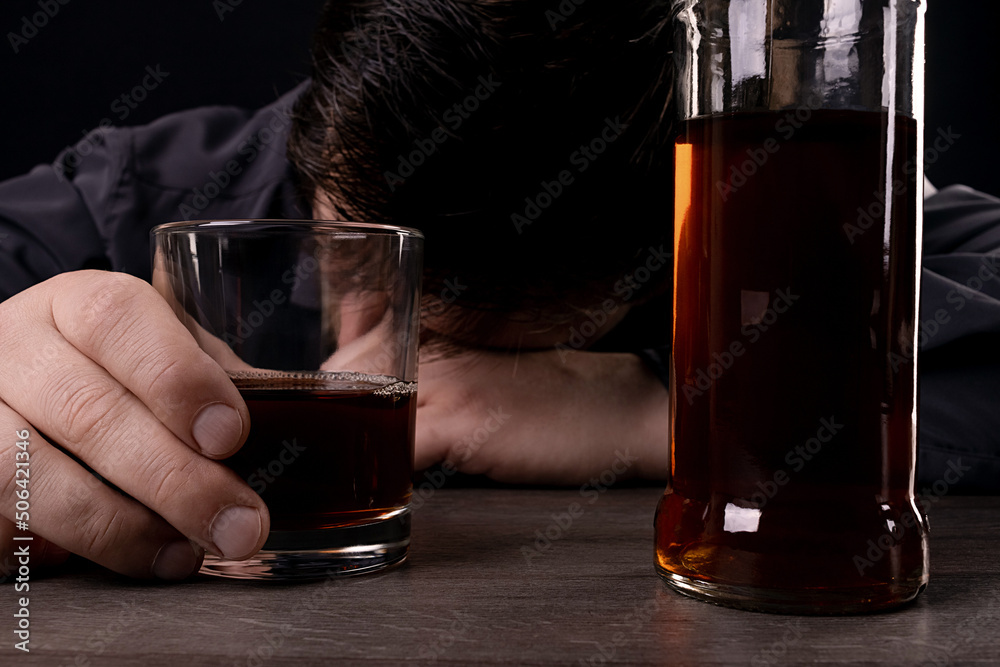 Drunk man fell asleep at the table, drinking alcohol. Drunk man fell asleep at the table, drinking alcohol.
