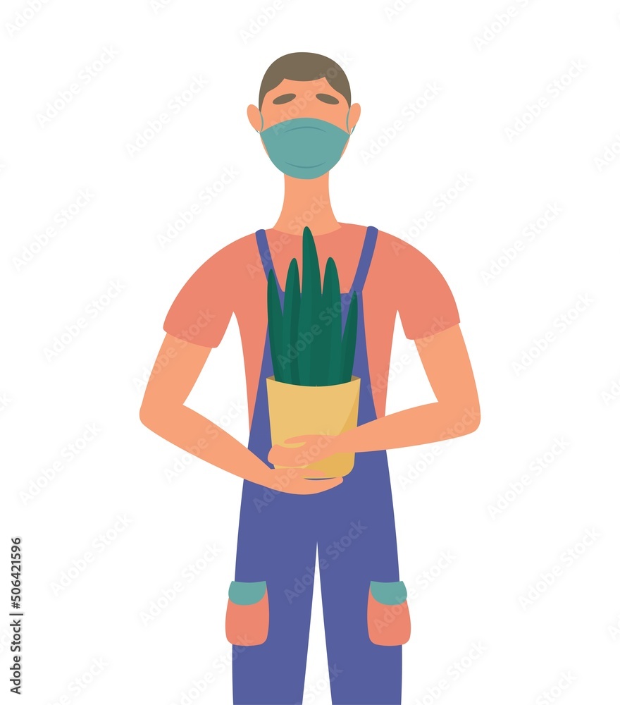Moving and moving to a new house. the concept of service movers. loader in a medical mask holding a houseplant. Moving and moving to a new house. the concept of service movers. loader in a medical mask holding a houseplant.