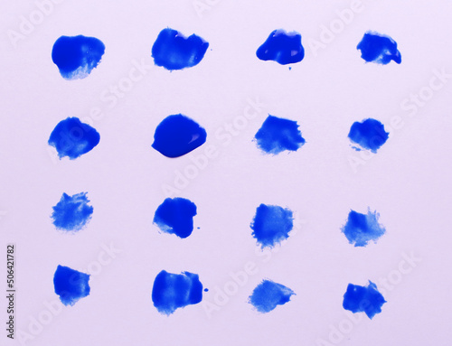 Abstract blue paint drops brushes isolated on white