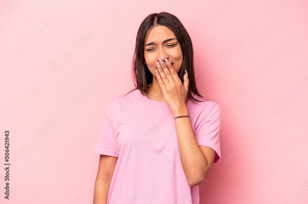 Young hispanic woman isolated on pink background yawning showing a tired gesture covering mouth with hand. Young hispanic woman isolated on pink background yawning showing a tired gesture covering mouth with hand.