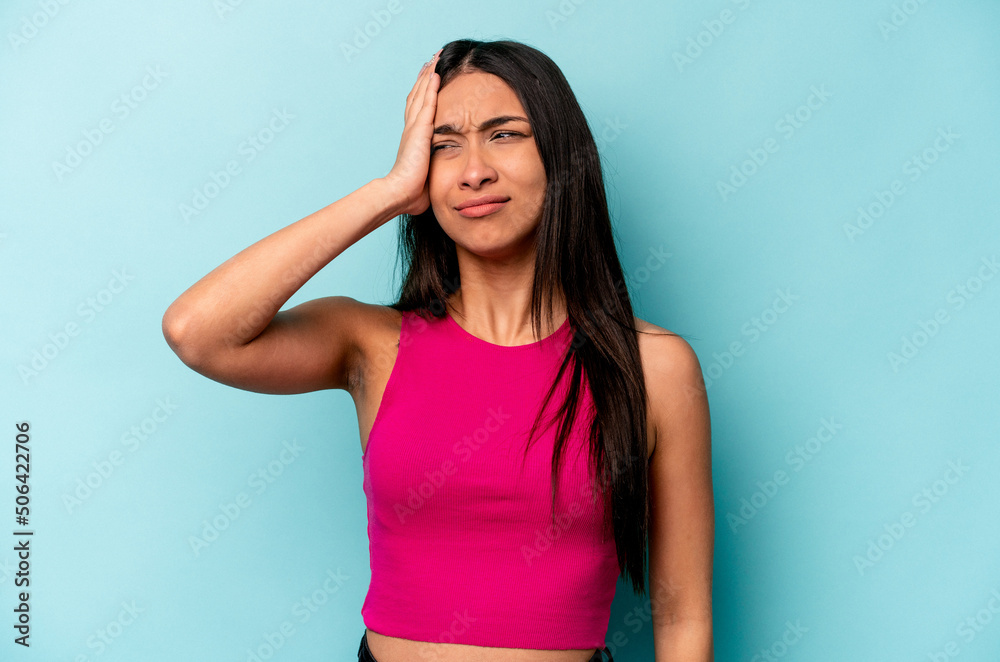 Young hispanic woman isolated on blue background tired and very sleepy keeping hand on head. Young hispanic woman isolated on blue background tired and very sleepy keeping hand on head.