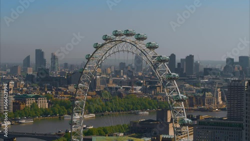 Aerial Shot of The London Eye Wheel, River Thames and Iconic Business Buildings b photo