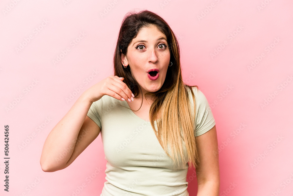 Young caucasian woman isolated on pink background laughing about something, covering mouth with hands. Young caucasian woman isolated on pink background laughing about something, covering mouth with hands.