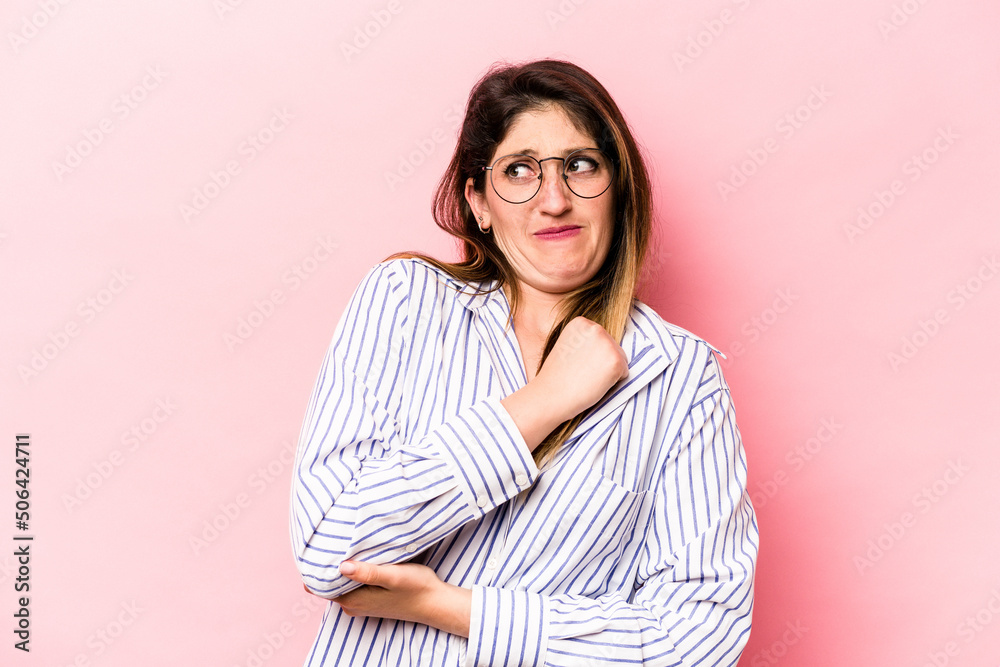 Young caucasian woman isolated on pink background confused, feels doubtful and unsure. Young caucasian woman isolated on pink background confused, feels doubtful and unsure.