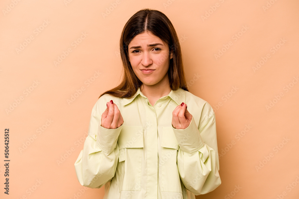 Young hispanic woman isolated on beige background showing that she has no money. Young hispanic woman isolated on beige background showing that she has no money.