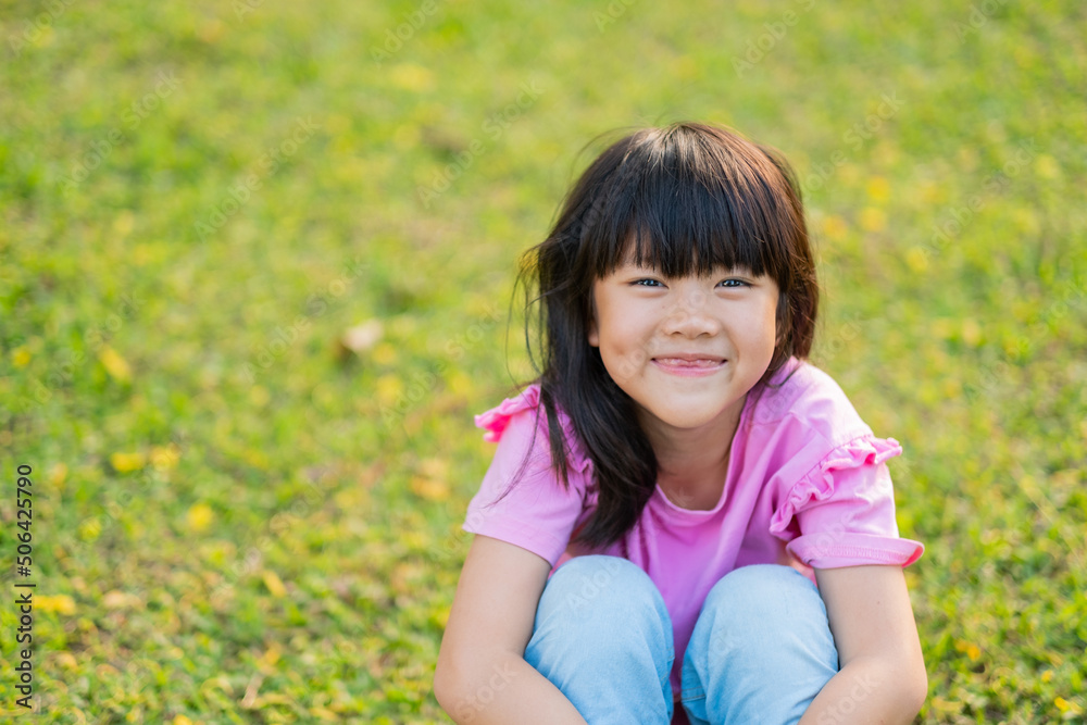 happy girl sitting on the grass, play ground happy girl sitting on the grass, play ground