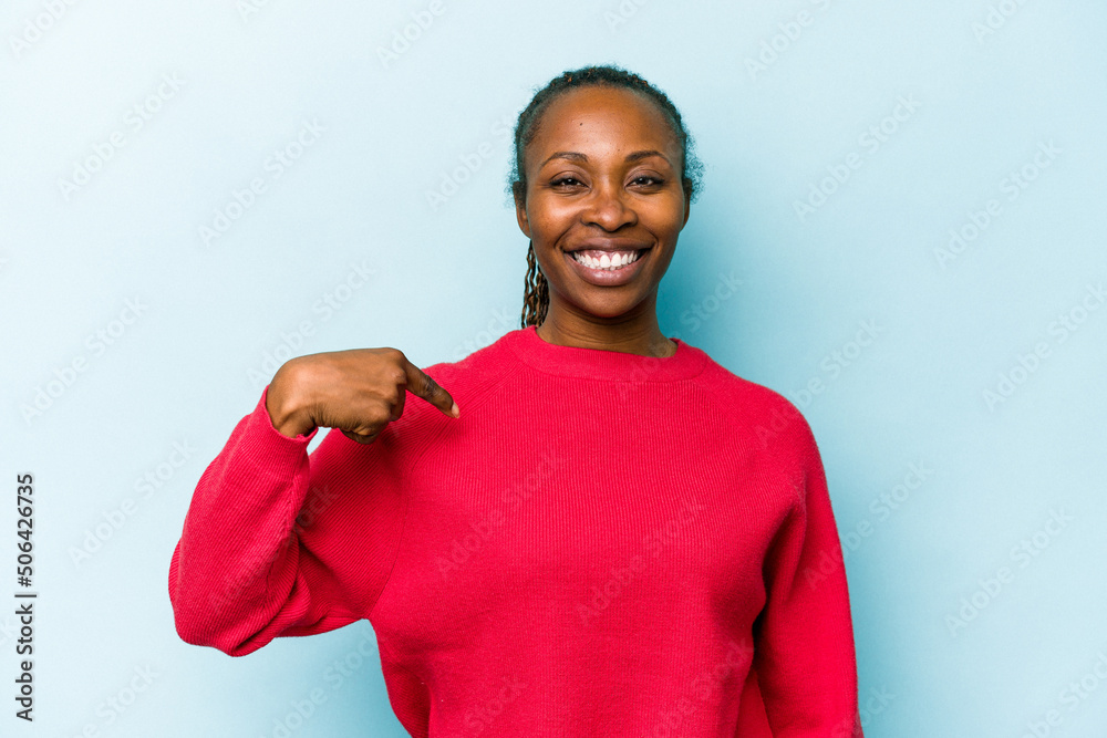 Young african american woman isolated on blue background person pointing by hand to a shirt copy space, proud and confident Young african american woman isolated on blue background person pointing by hand to a shirt copy space, proud and confident