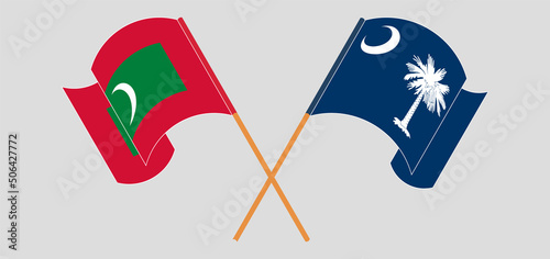 Crossed and waving flags of Maldives and The State of South Carolina