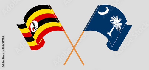 Crossed and waving flags of Uganda and The State of South Carolina