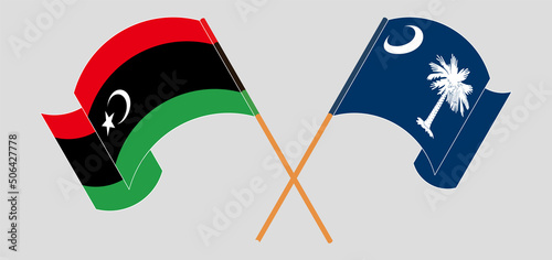 Crossed and waving flags of Libya and The State of South Carolina