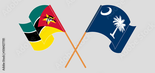 Crossed and waving flags of Mozambique and The State of South Carolina
