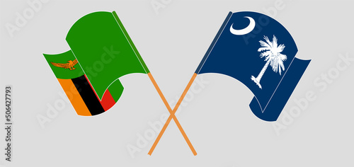 Crossed and waving flags of Zambia and The State of South Carolina