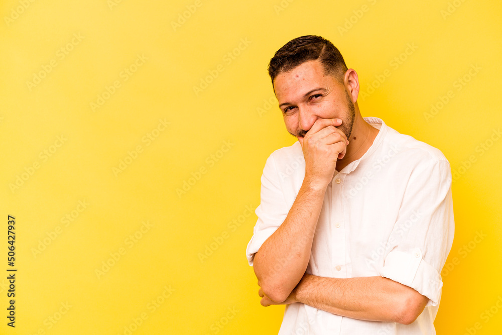 Young hispanic man isolated on yellow background laughing happy, carefree, natural emotion. Young hispanic man isolated on yellow background laughing happy, carefree, natural emotion.