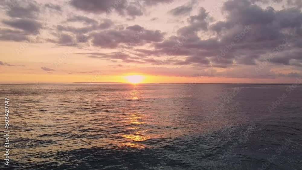 Shooting the ocean from a height with a drone. Beautiful pink sunset with a view of the dark ocean and waves. Big waves crash against the rocks in the setting sun. Video from the trip Shooting the ocean from a height with a drone. Beautiful pink sunset with a view of the dark ocean and waves. Big waves crash against the rocks in the setting sun. Video from the trip