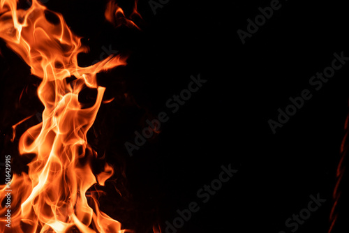 Strong orange campfire flame isolated on black night background with copyspace © Ievgen Skrypko