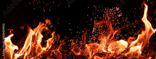 Fire flame isolated on black background. Campfire glow over dark night sky