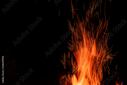 Campfire flame orange sparks with long exposure isolated on black background