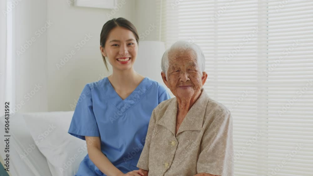 Portrait of young Asian woman, nurse, caregiver, carer of nursing home and senior Asian woman smiling and laughing at home. Look at camera Portrait of young Asian woman, nurse, caregiver, carer of nursing home and senior Asian woman smiling and laughing at home. Look at camera