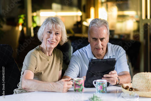 senior couple using ipad at home photo