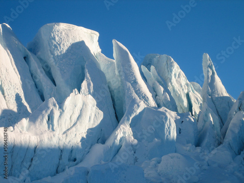 Sharp jagged glacial seracs of the Matanuska Glacier contrasted against a bluebird sky and no people