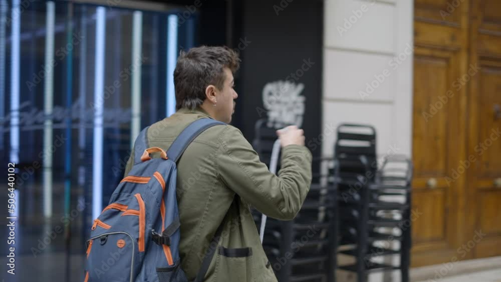 Close up shot taken of a male magician wearing a blue backpack while walking trying to find a customer to show his tricks at daytime. Close up shot taken of a male magician wearing a blue backpack while walking trying to find a customer to show his tricks at daytime.