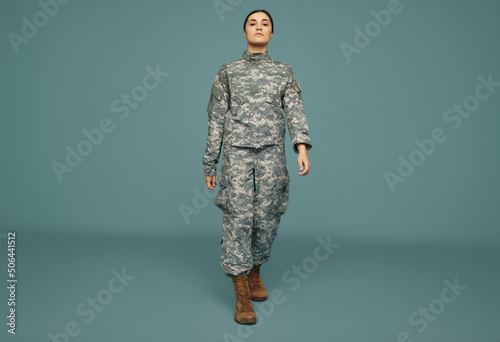 Patriotic army soldier marching in a studio photo