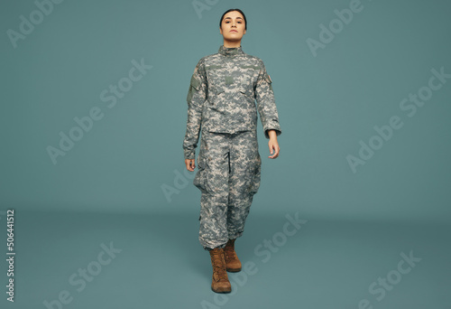 Patriotic army soldier marching in a studio